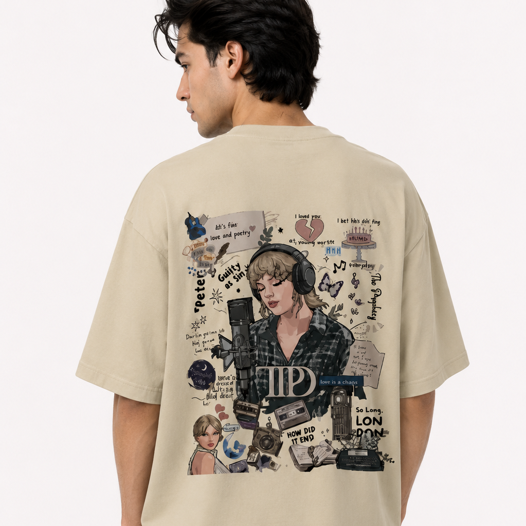 A man shown from the back wearing an oversized beige graphic T-shirt. The shirt features a large, detailed collage print on the back with a portrait of Taylor Swift, cassette tapes, a microphone, and various text elements.